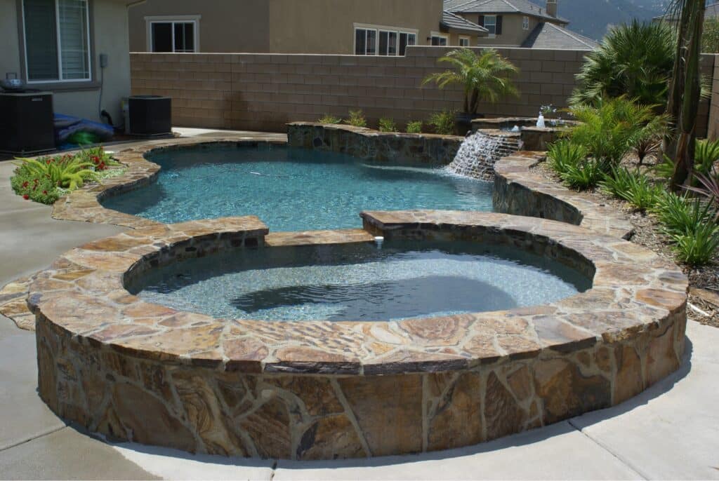 Backyard pool with a hot tub