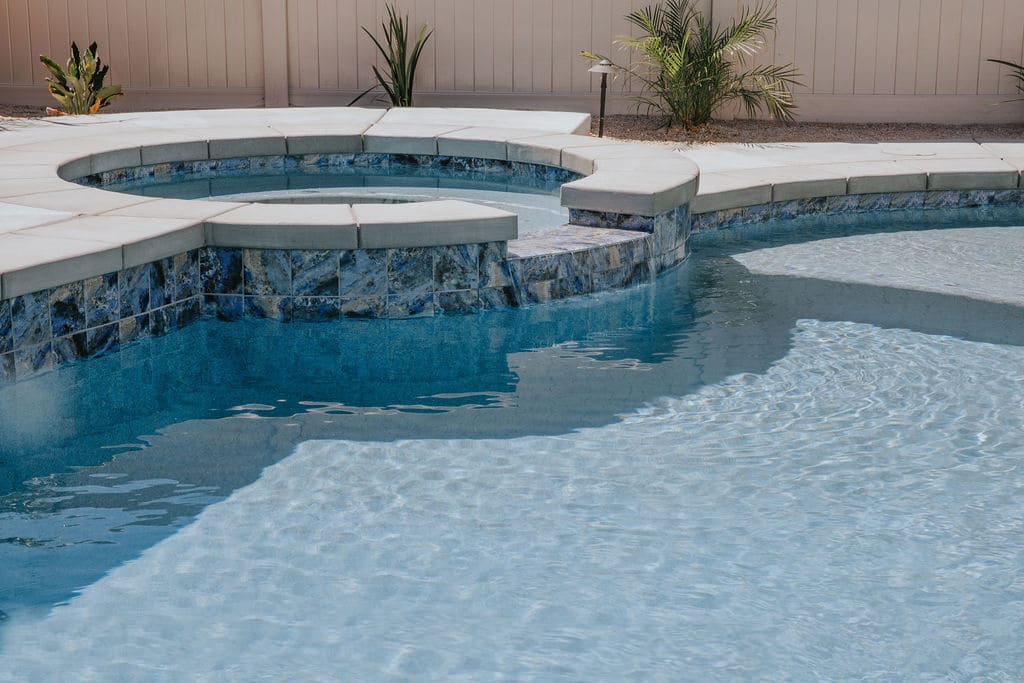 Backyard custom pool with a hot tub