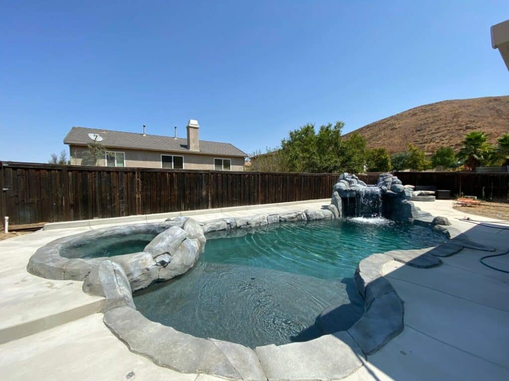 Backyard pool with a hot tub