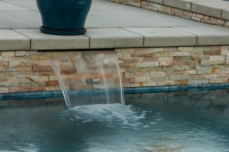Custom backyard pool with a water fall