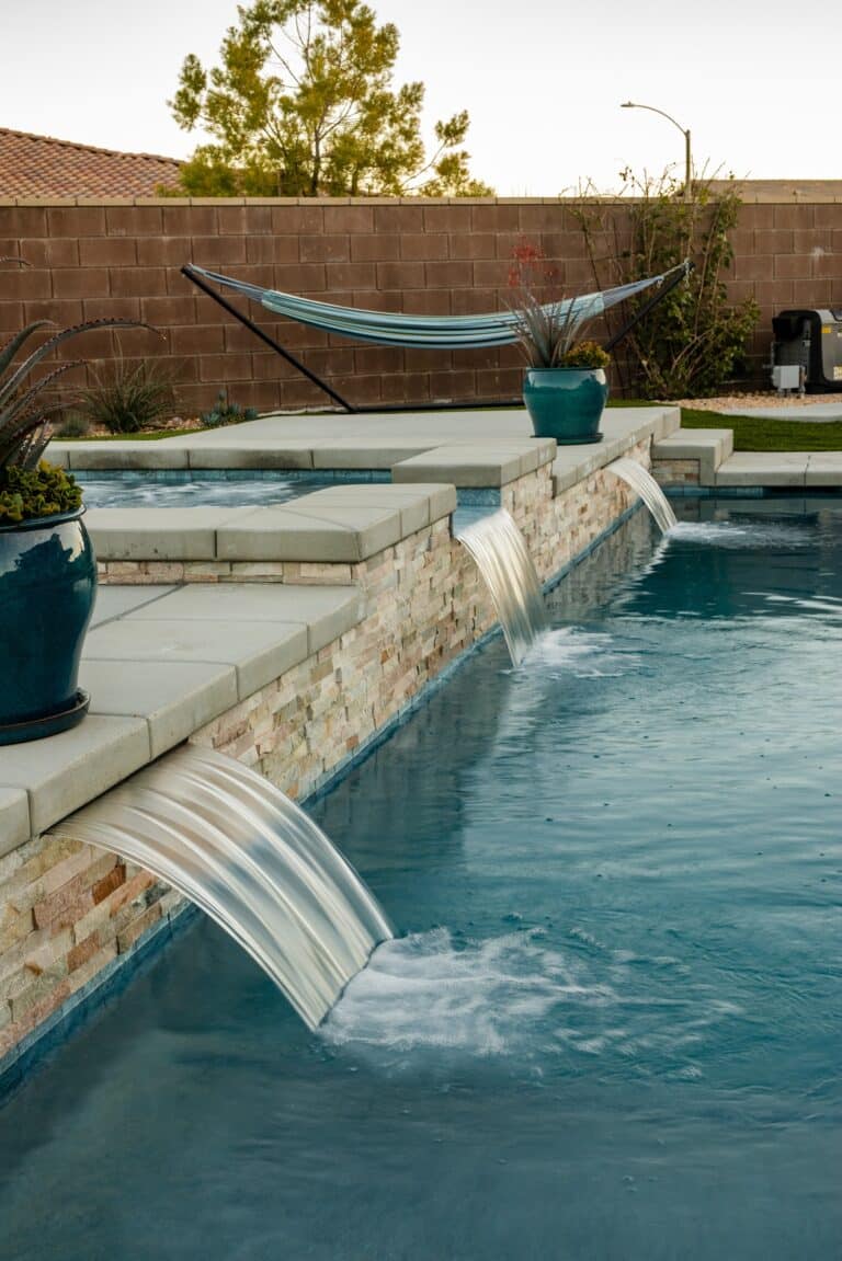 Custom backyard pool with a hot tub