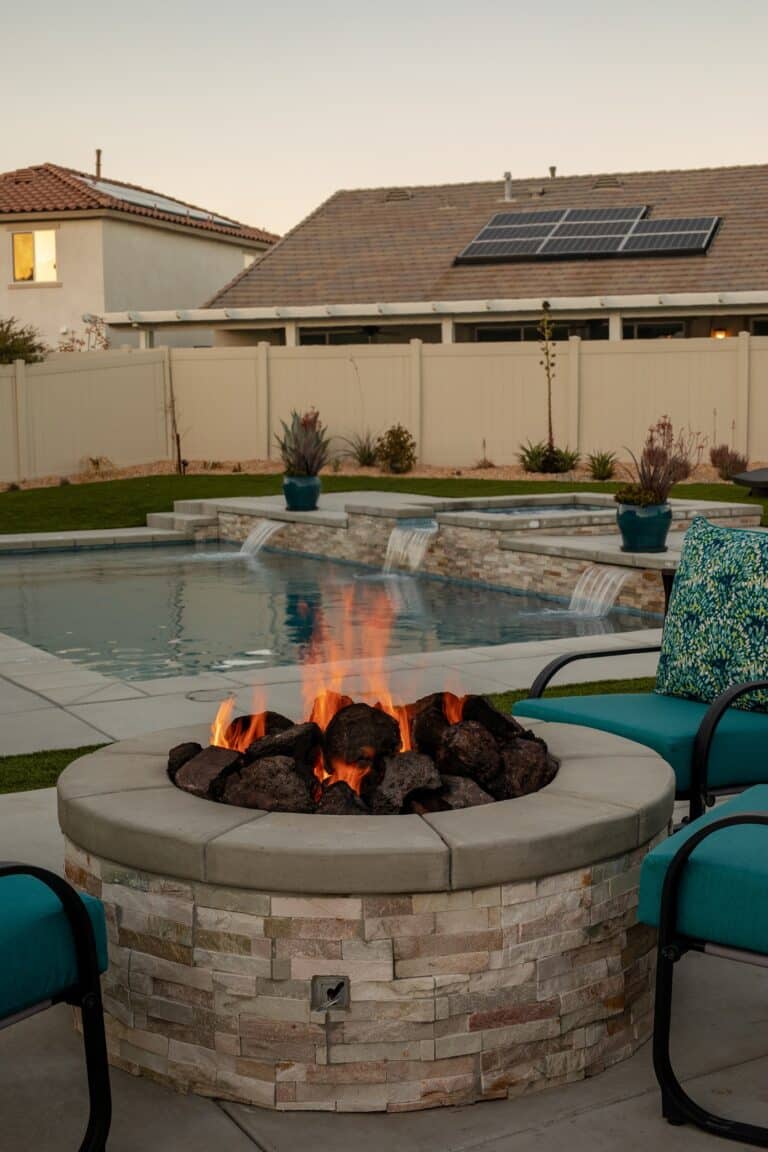 Custom backyard pool with a fire pit